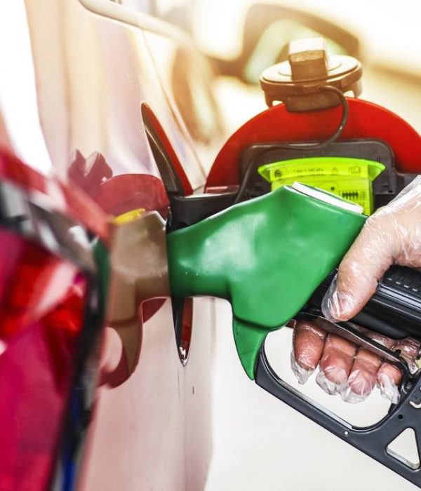 94445620_Man-holding-pump-and-refueling-gasoline-at-gas-stationPetrol-filling-into-car-tank.